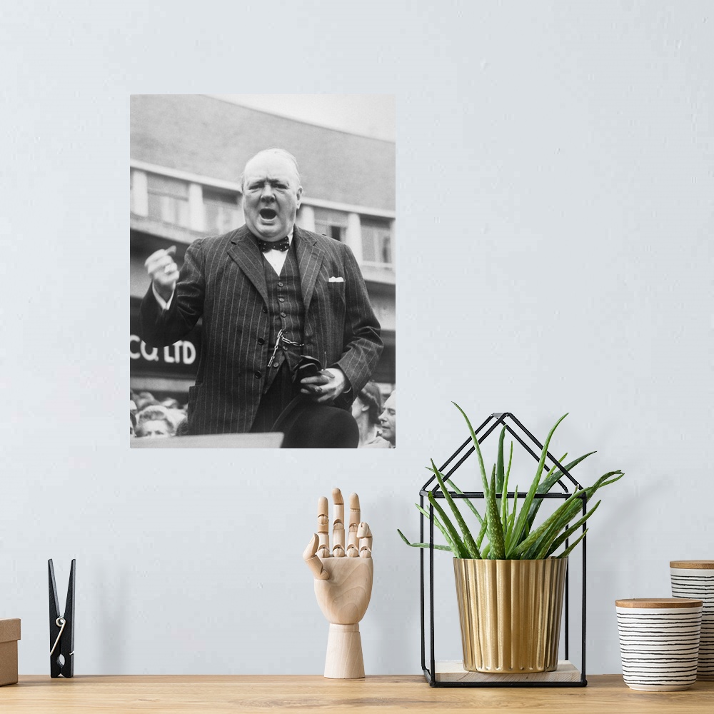 A bohemian room featuring British history photograph of Prime Minister Winston Churchill during an election campaign speech...