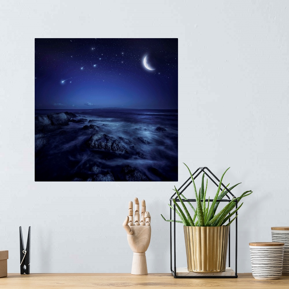 A bohemian room featuring Rising moon over ocean and boulders against starry sky and falling meteorites.