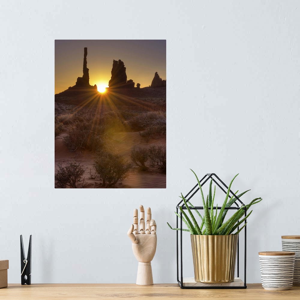 A bohemian room featuring A sunburst through the famous Totem Pole formation in Monument Valley, Utah.