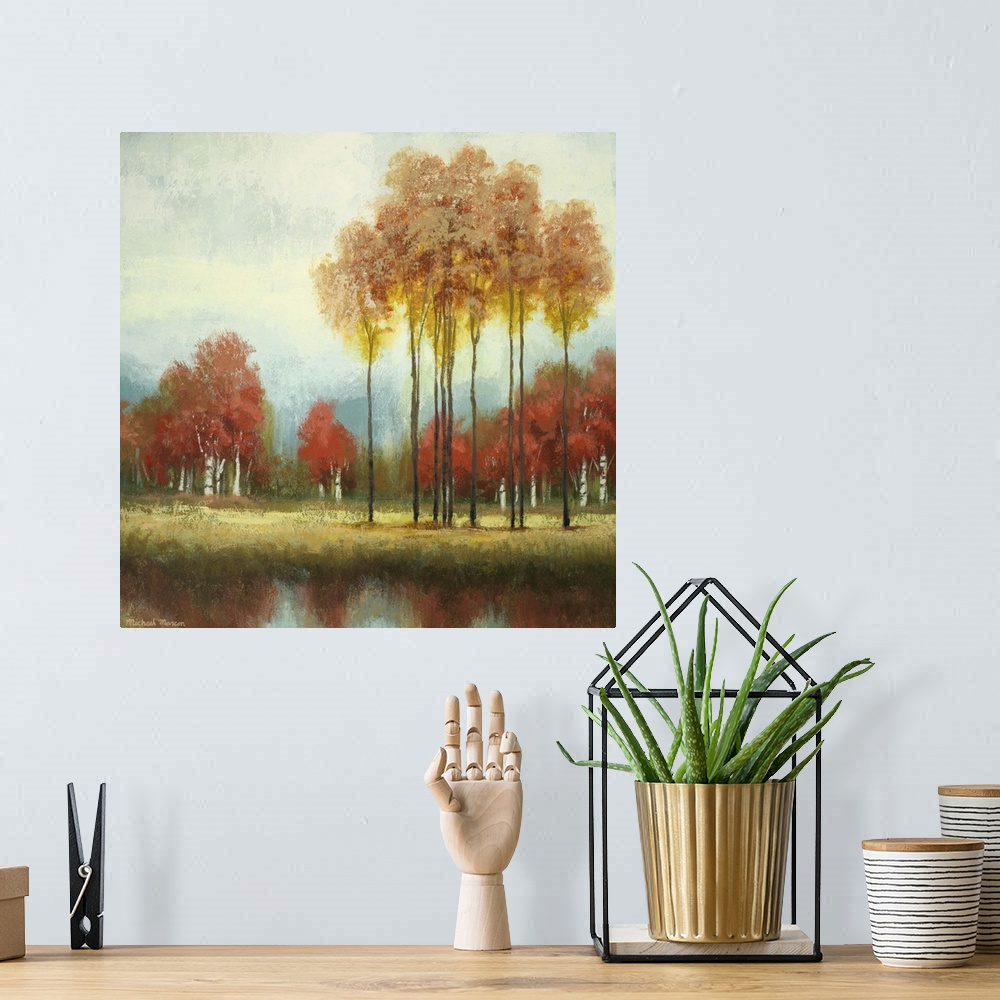 A bohemian room featuring Painting of a countryside clearing with tall and short trees in autumn foliage in front a river.