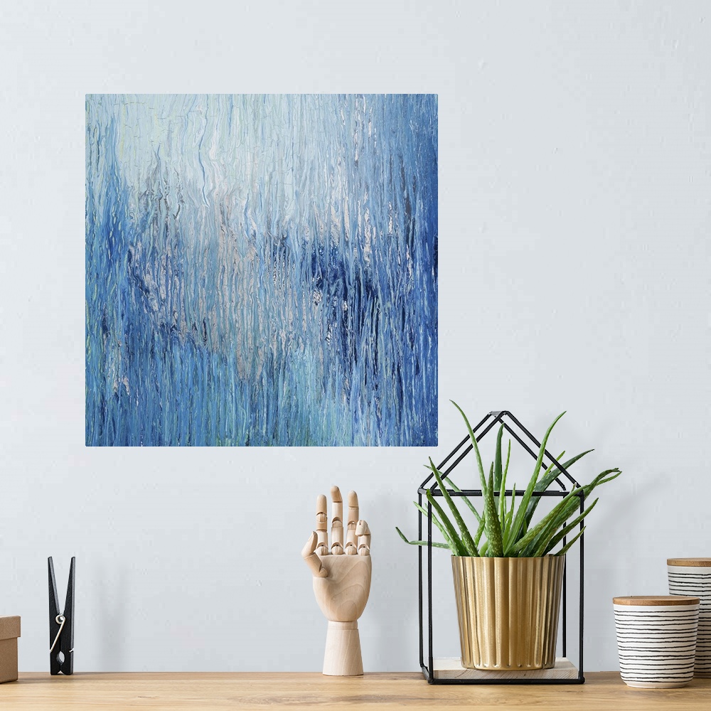 A bohemian room featuring Abstract artwork in shades of blue resembling glacial ice.