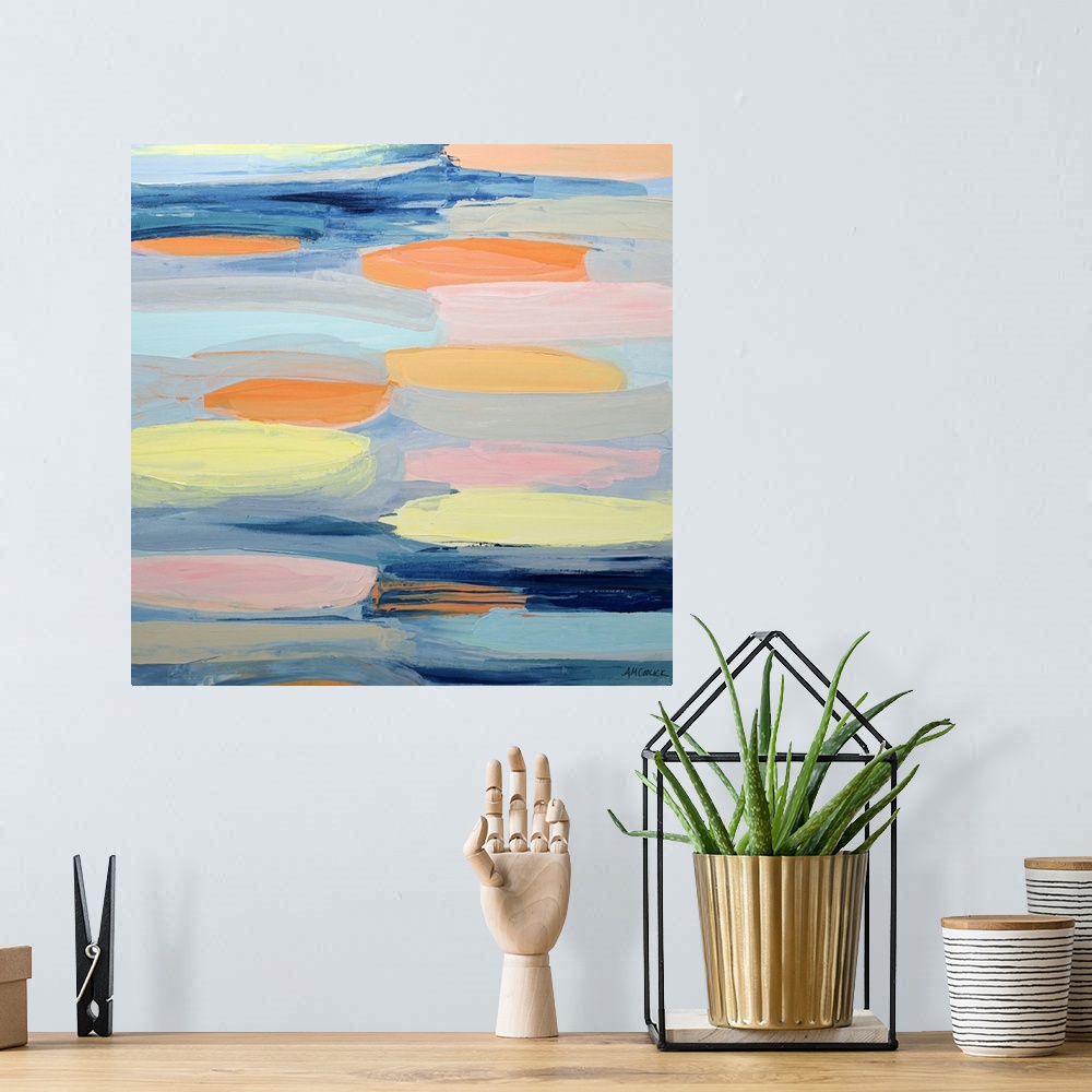 A bohemian room featuring Blue, yellow, and orange abstract artwork.