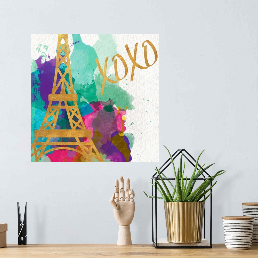 A bohemian room featuring The Eiffel Tower in gold on multicolored watercolor splashes.