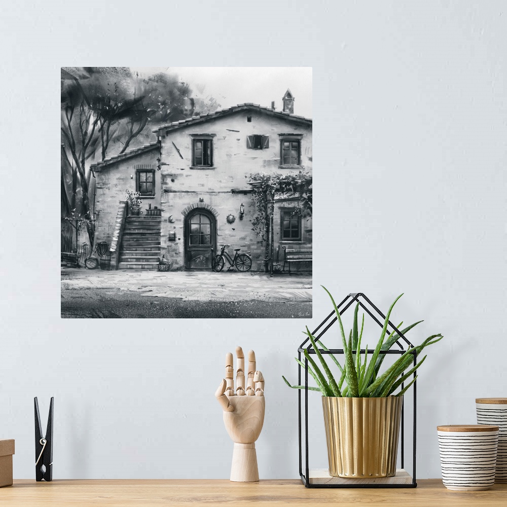 A bohemian room featuring Monochrome painting of a rustic Tuscan villa structure.