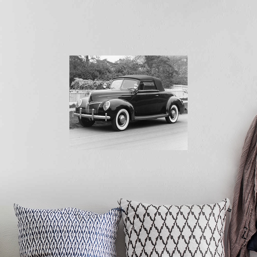 A bohemian room featuring A 1939 Ford Deluxe Coupe. Photograph.