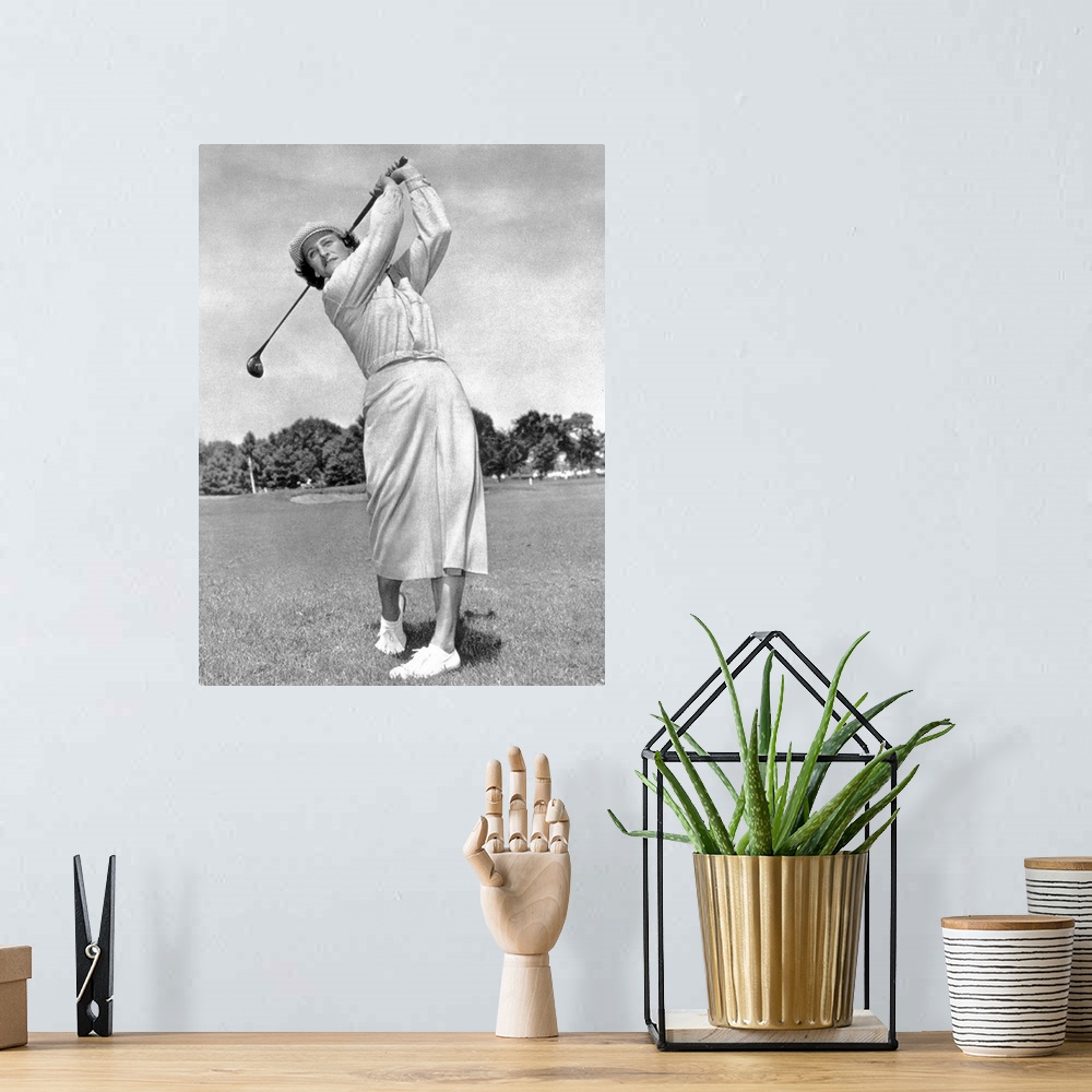 A bohemian room featuring (1911-1956). Ne Mildred Ella Didrikson. American athlete. Photographed while swinging a golf club...