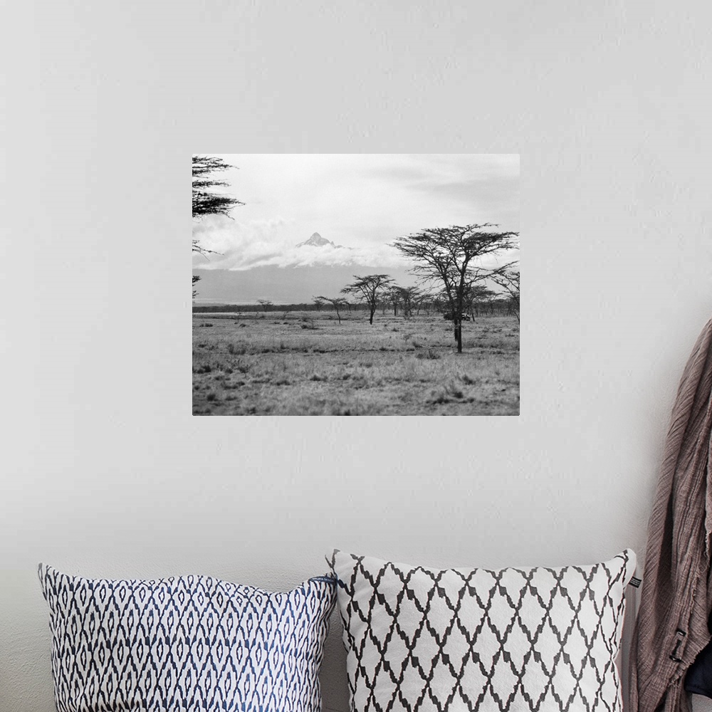A bohemian room featuring Landscape view in Kenya, with Mount Kenya seen in the distance. Photographed in 1936.