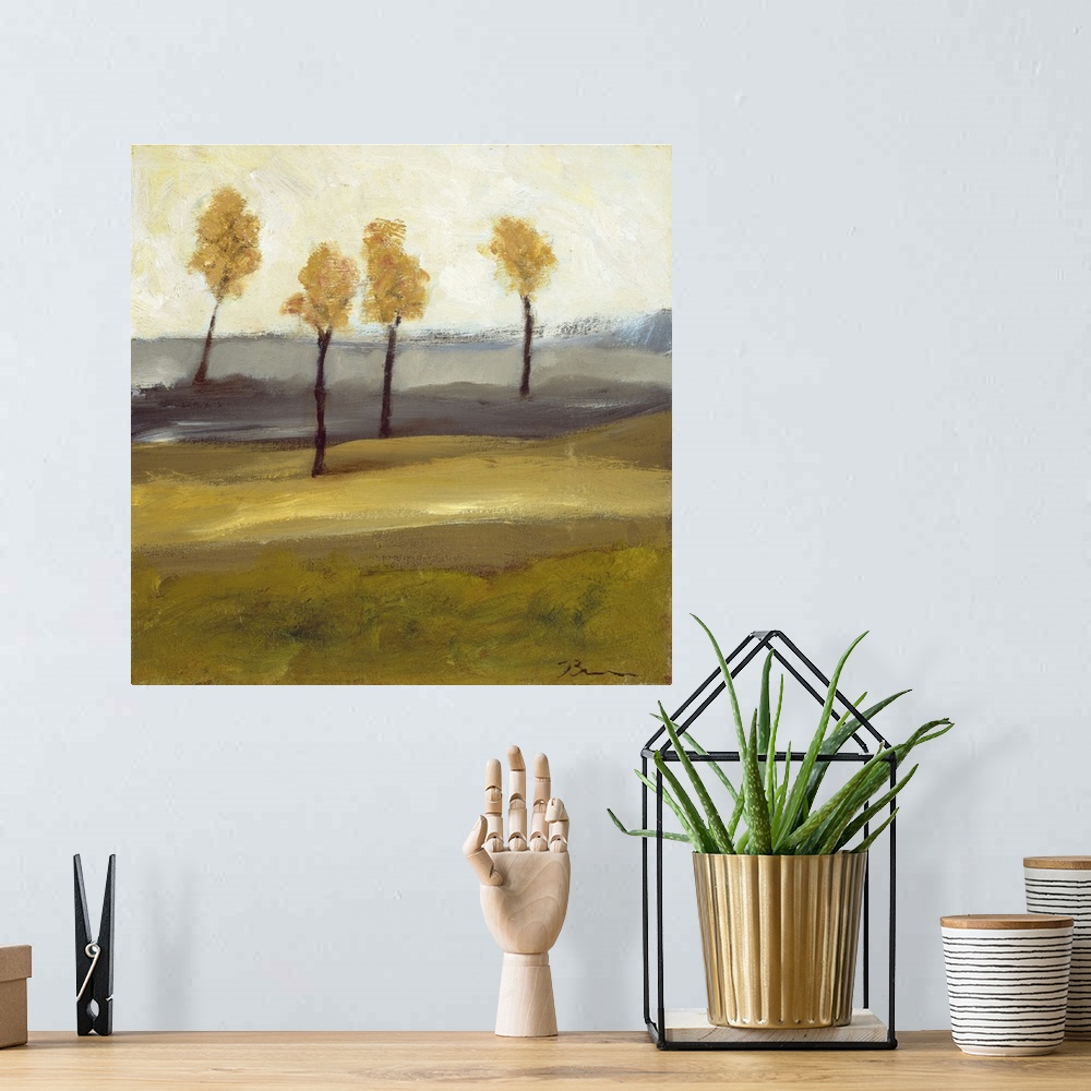 A bohemian room featuring Contemporary landscape painting with four trees in autumn foliage standing together in the distance.