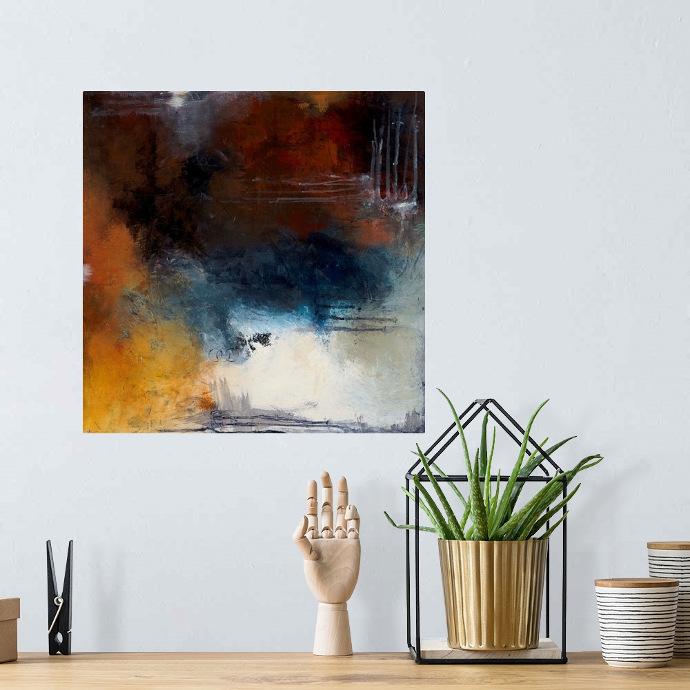 A bohemian room featuring Square abstract painting with splotches of deep red, orange, and blue hues and a pop of bright wh...
