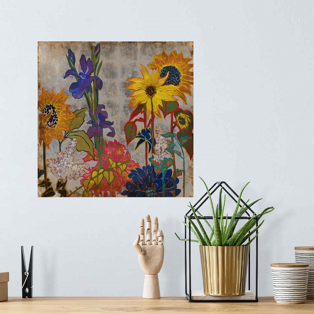 A bohemian room featuring A square painting of primary colored wild flowers in a garden with a silver square patterned back...