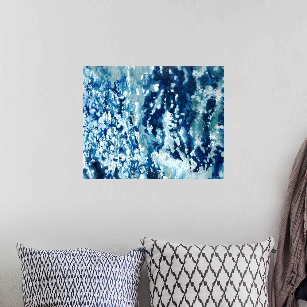 A bohemian room featuring Abstract painting with shades of blue marbled together with white.