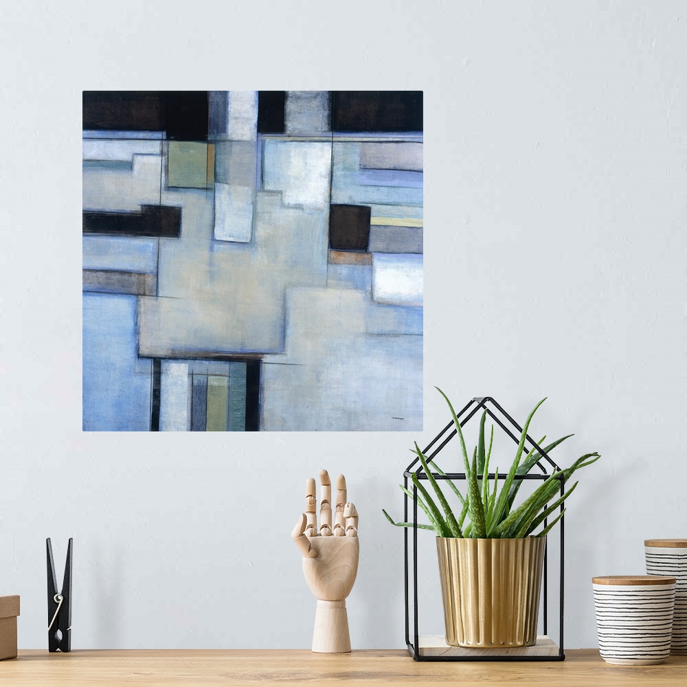 A bohemian room featuring A square abstract painting with square shapes in shades of blue.
