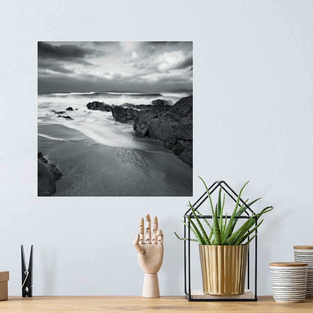 A bohemian room featuring A peaceful cove with sand and surf