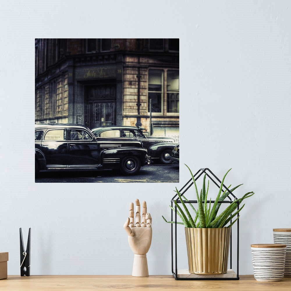 A bohemian room featuring A 1941 cadillac series-61 and a 1941 chevrolet master deluxe sedan parked in the street with full...