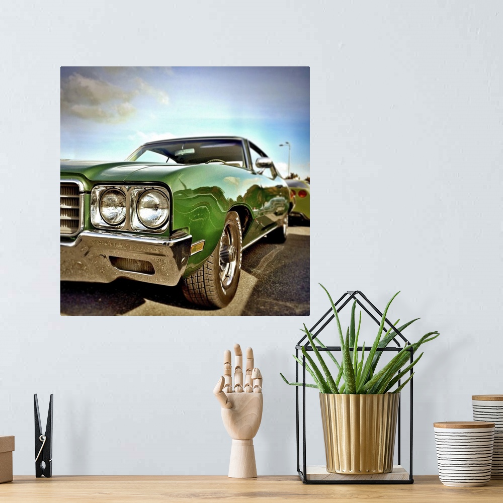 A bohemian room featuring Green classic USA car form the 1970's with chrome fenders.