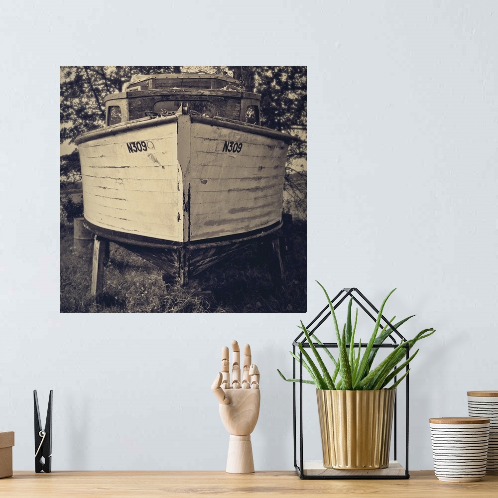 A bohemian room featuring Bow view of an old holiday cruiser moored on dry land under trees