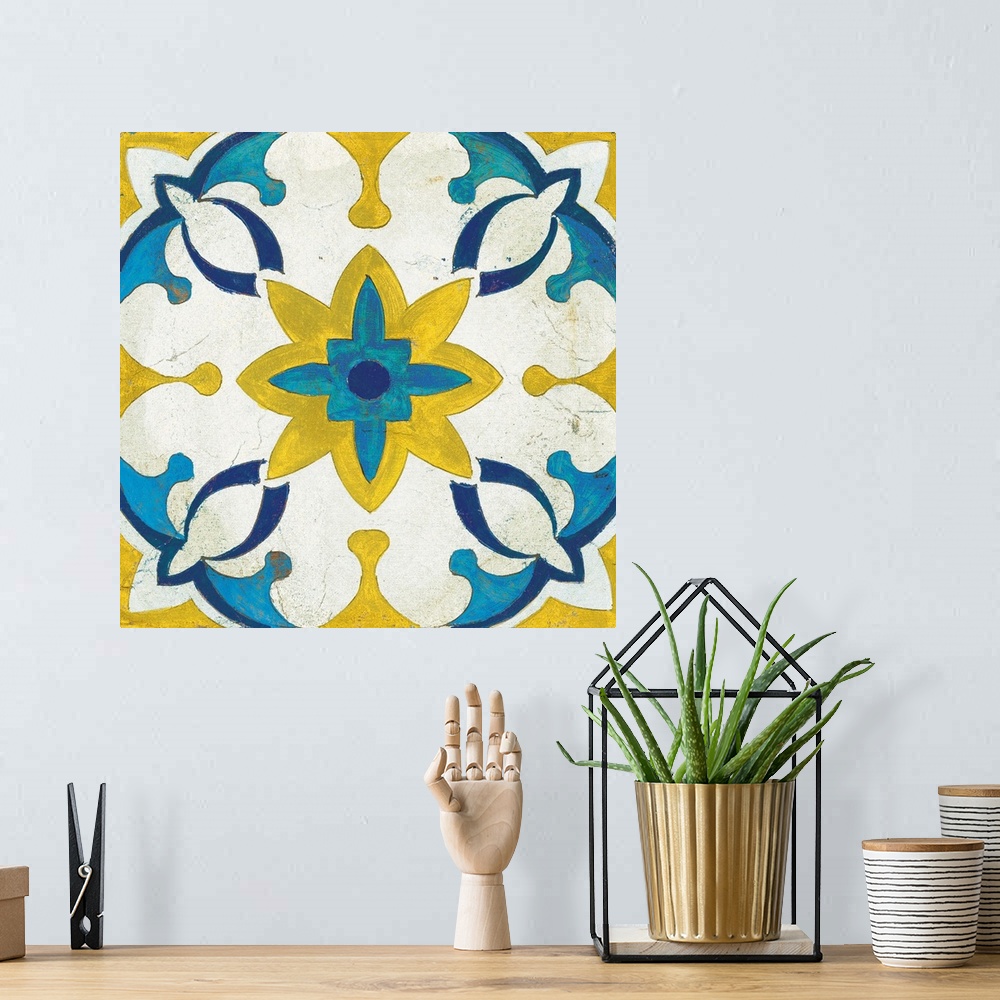 A bohemian room featuring Decorative square painting of a floral tile design in colors of blue, yellow and white.