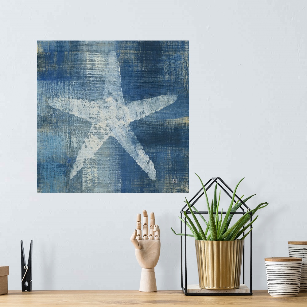 A bohemian room featuring Square artwork of a white starfish among a white and blue brushed finish.