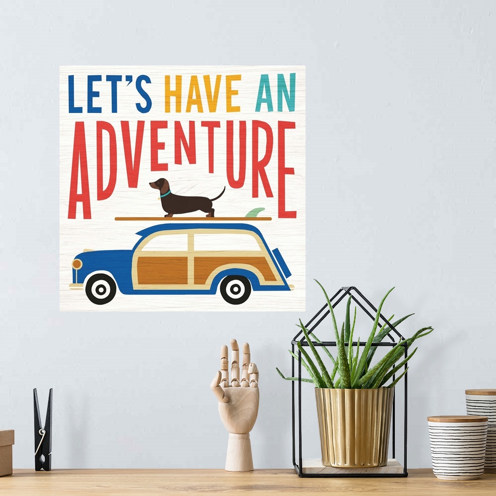 A bohemian room featuring "LET'S HAVE AN ADVENTURE" illustration of a dachshund on top of a surf board on top of a wagon, h...