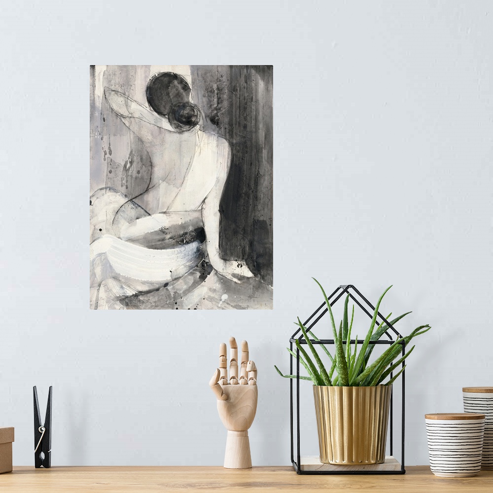 A bohemian room featuring A painting of the back of a nude woman wrapped in a white cloth done in black and white.