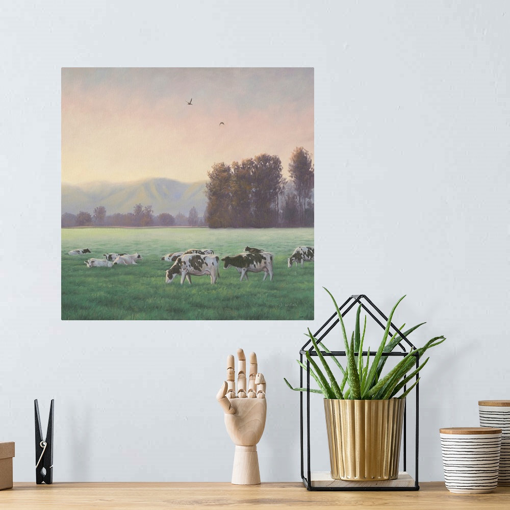 A bohemian room featuring Square painting of a rural farm scene with grazing cows and mountains in the background.