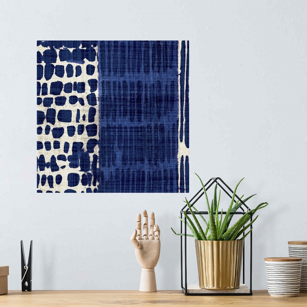 A bohemian room featuring Contemporary abstract artwork of different patterns in dark blue and cream.
