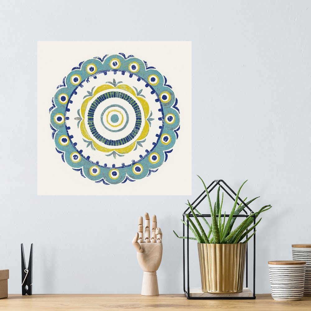A bohemian room featuring Square decor with a mandala design in the center made in shades of blue, green, and yellow on a w...