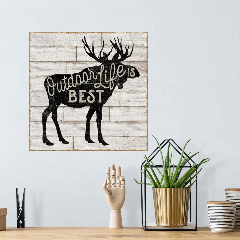 A bohemian room featuring Contemporary rustic cabin decor artwork of a silhouetted nature element with a typographic sentim...