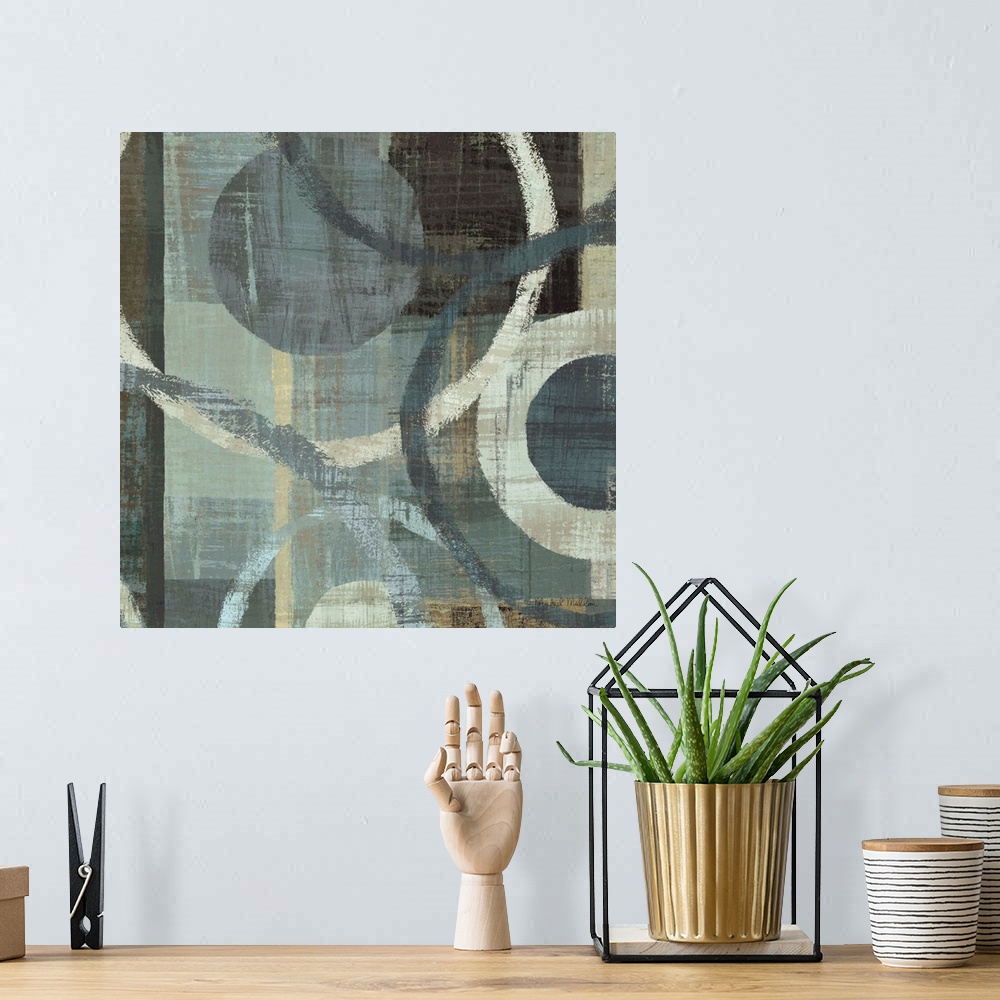 A bohemian room featuring Abstract painting with circles of different sizes against a background of cool toned brush strokes.