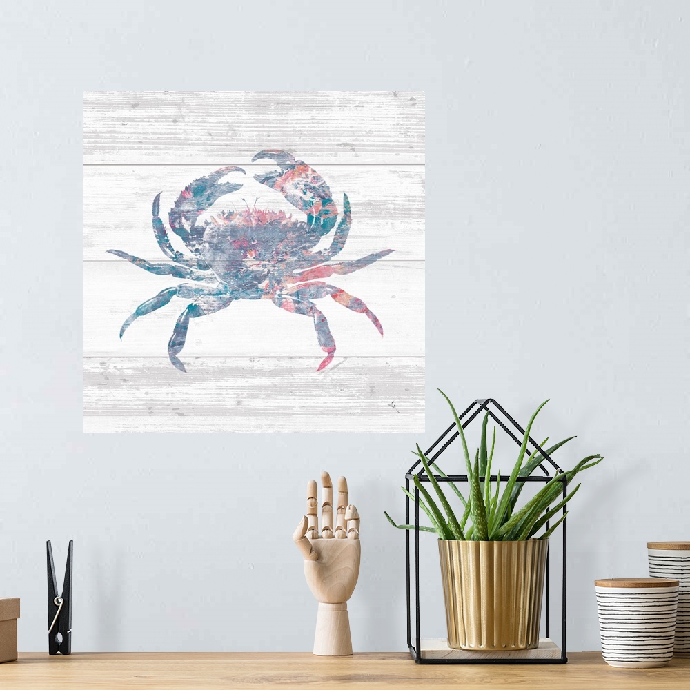 A bohemian room featuring Square beach decor with a silhouette of a blue, pink, red, and white crab on a rustic, white, woo...