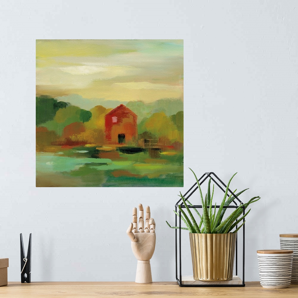 A bohemian room featuring A contemporary painting of a red barn and fence framed by fall trees.