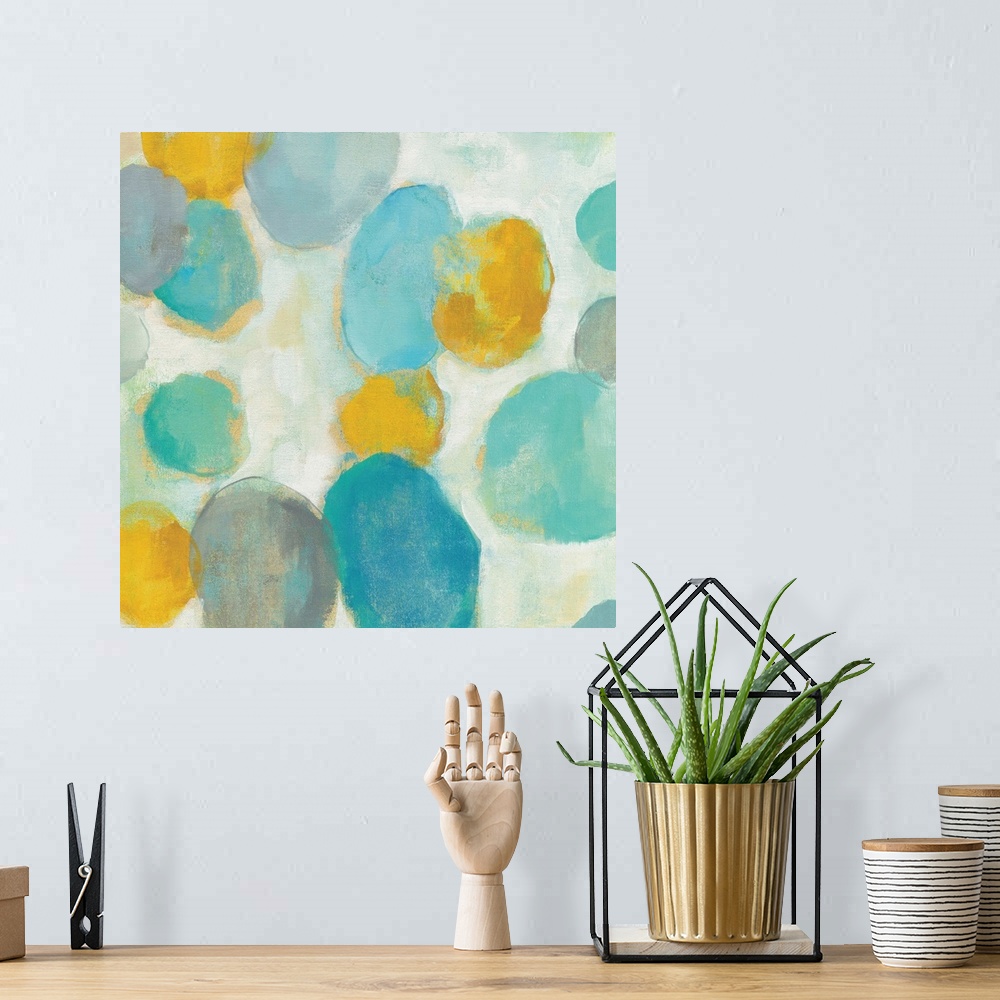 A bohemian room featuring Abstract artwork of bright circle shapes in yellow and teal.