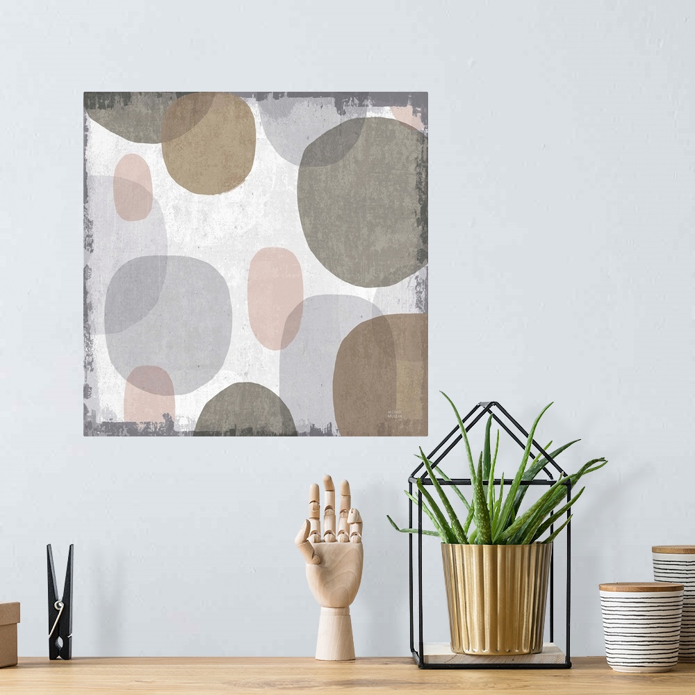 A bohemian room featuring Large abstract artwork with oblong shapes running down the canvas in brown, gray, faded pink, and...