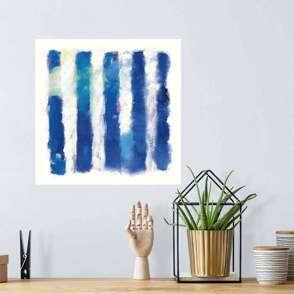 A bohemian room featuring Abstract art of deep blue vertical stripes on white.