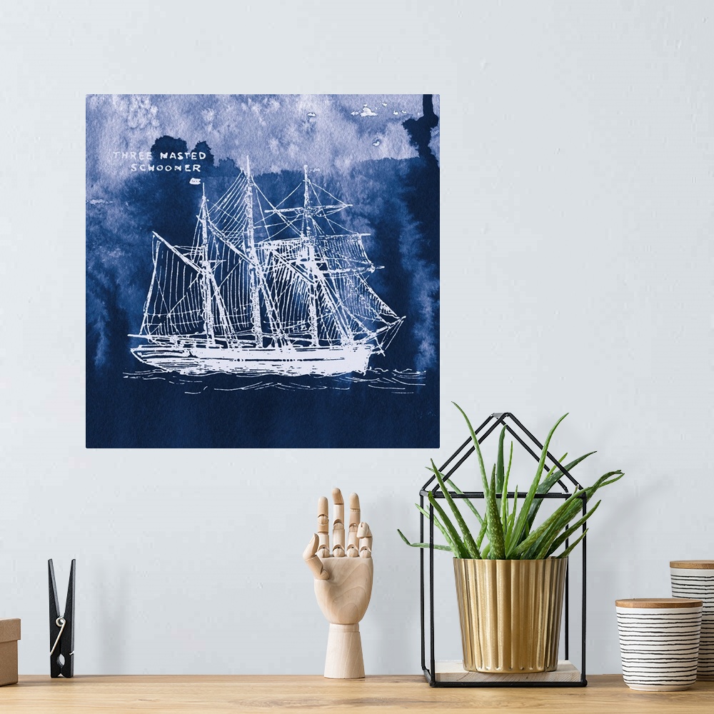 A bohemian room featuring Square art with a white silhouette of a sailboat on an indigo watercolor background and "Three Ma...