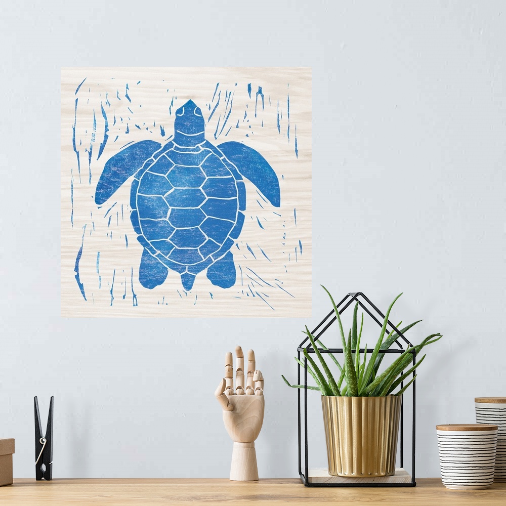 A bohemian room featuring Blue woodcut-style sea turtle print on wood.