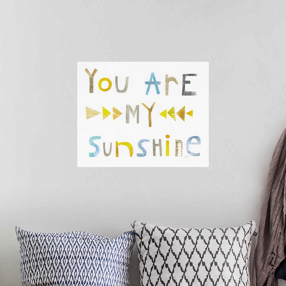 A bohemian room featuring Whimsy sentiment decor with the phrase "You Are My Sunshine" written in different colors.