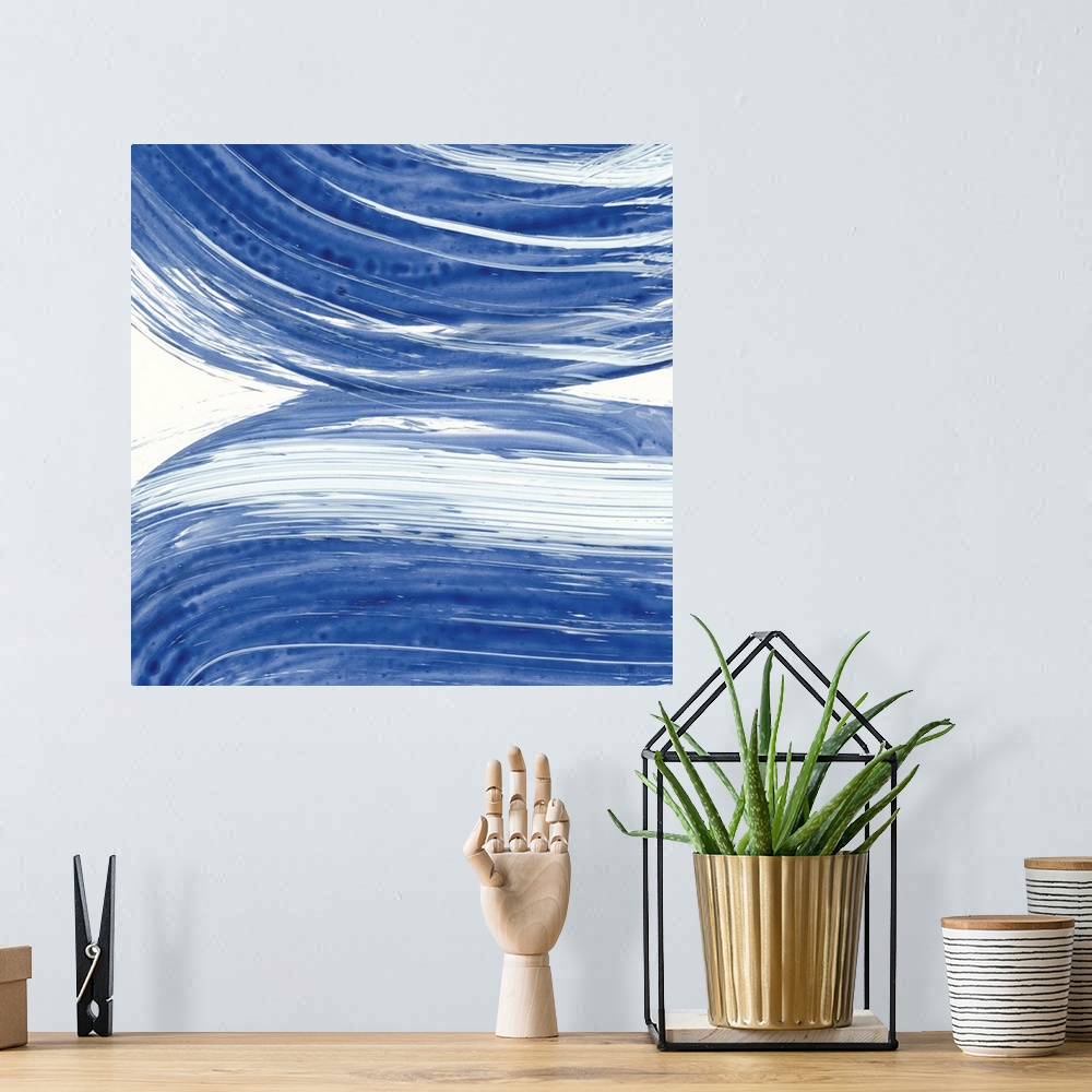 A bohemian room featuring Large square abstract painting of bold blue brush strokes in curved lines.