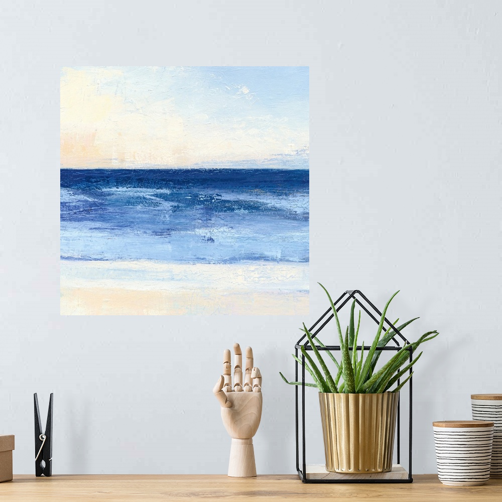 A bohemian room featuring Contemporary coastal themed painting of a calm sea seen from a beach shoreline.