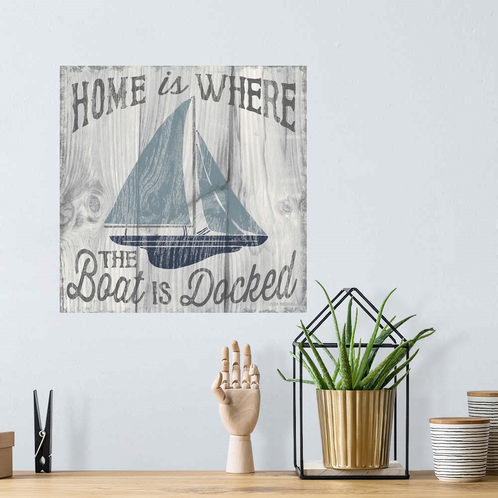 A bohemian room featuring "Home is Where the Boat is Docked" in grey with an illustration of a sailboat in shades of blue o...