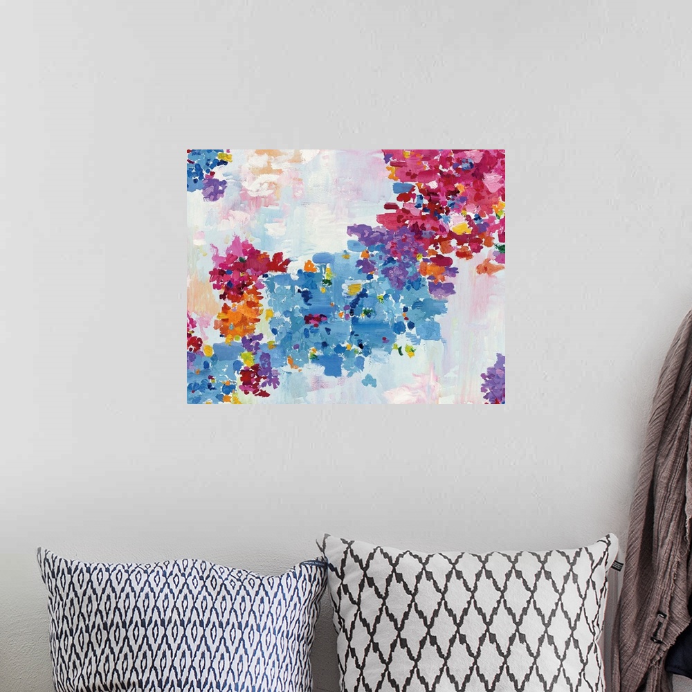 A bohemian room featuring Colorful painting of blue and pink flowers.