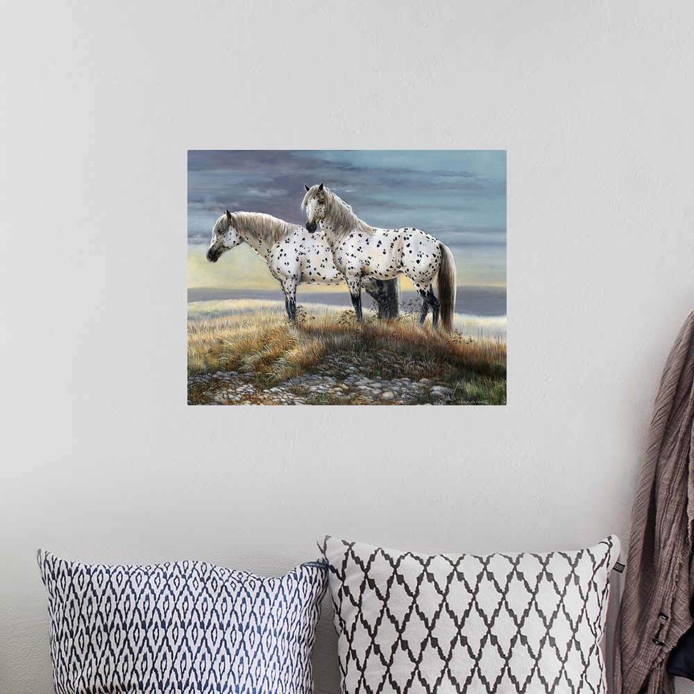 A bohemian room featuring Contemporary painting of two spotted horses standing on a countryside hill.