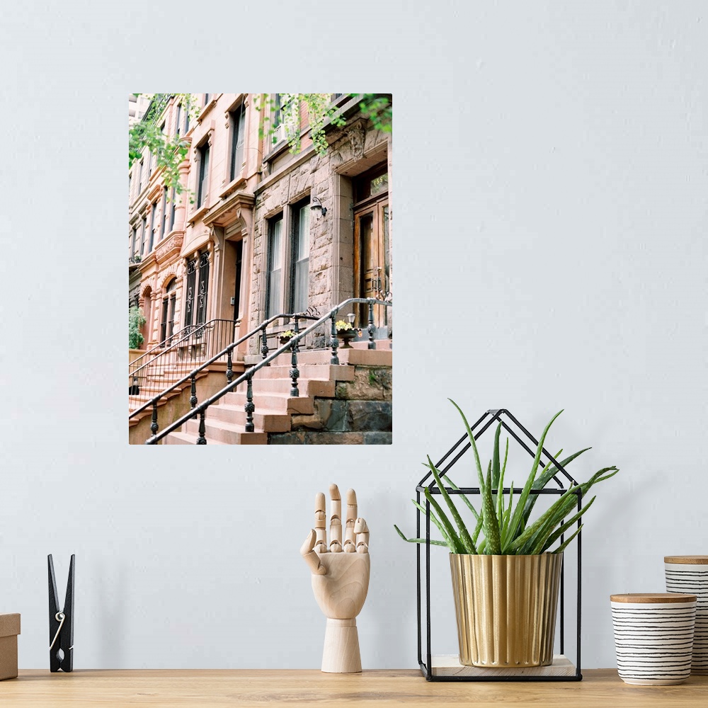 A bohemian room featuring Photograph of brick and cement steps leading up to an iconic Brownstone house in New York.
