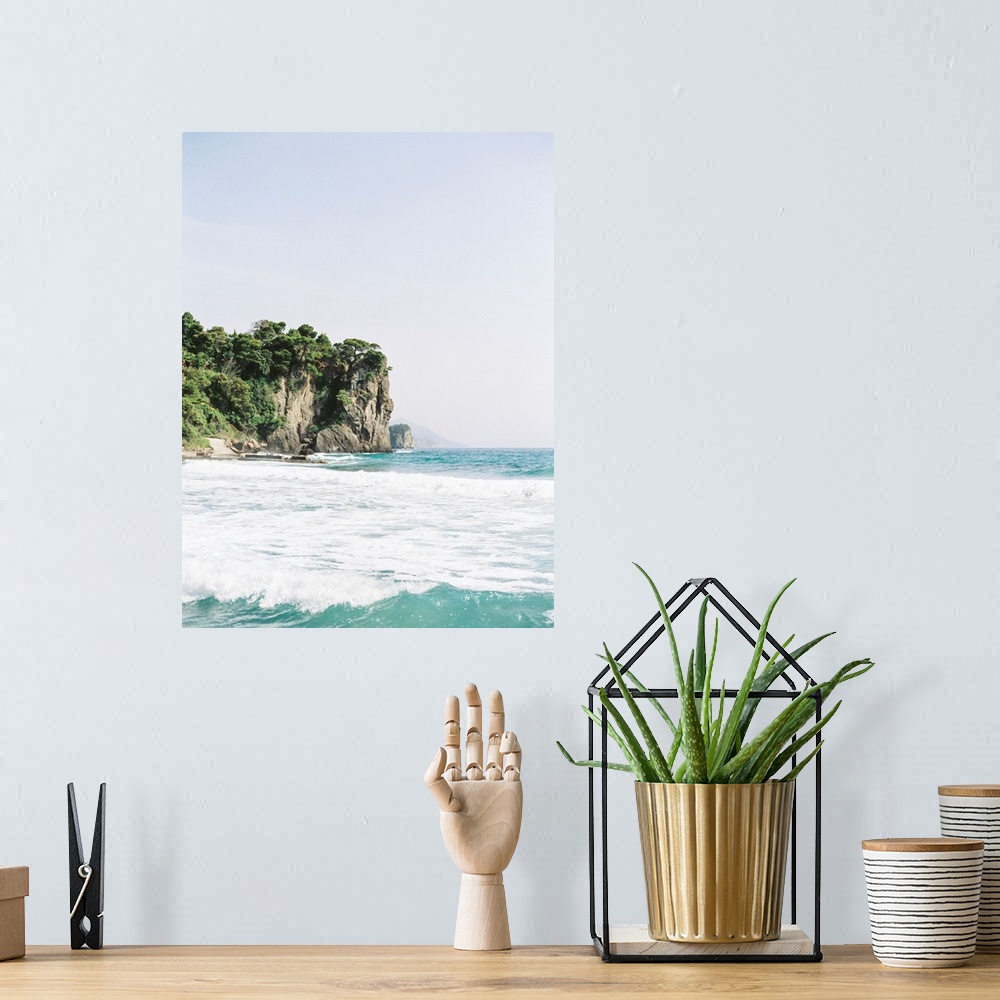 A bohemian room featuring Photograph of tall tree-topped cliffs above the ocean.