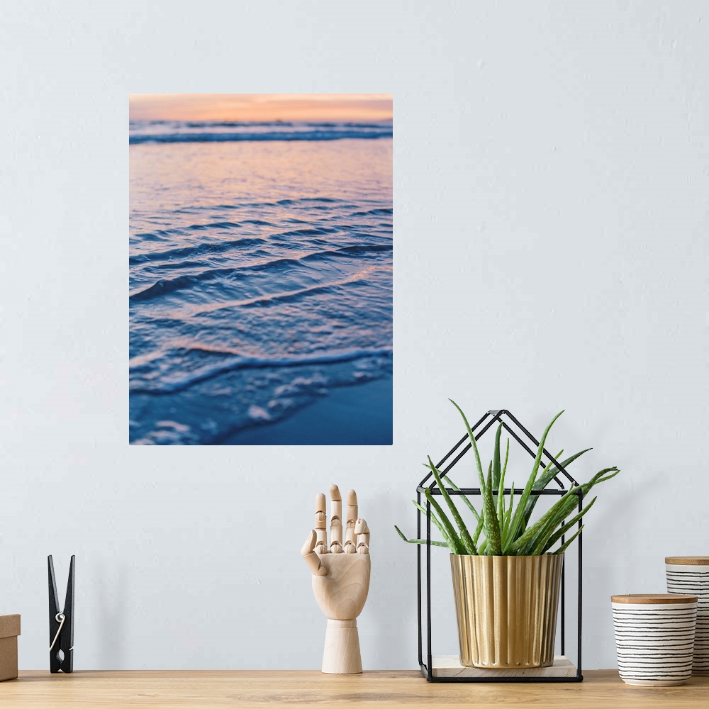 A bohemian room featuring A close up photograph of gentle waves lapping the beach under an early evening sky where the sun ...