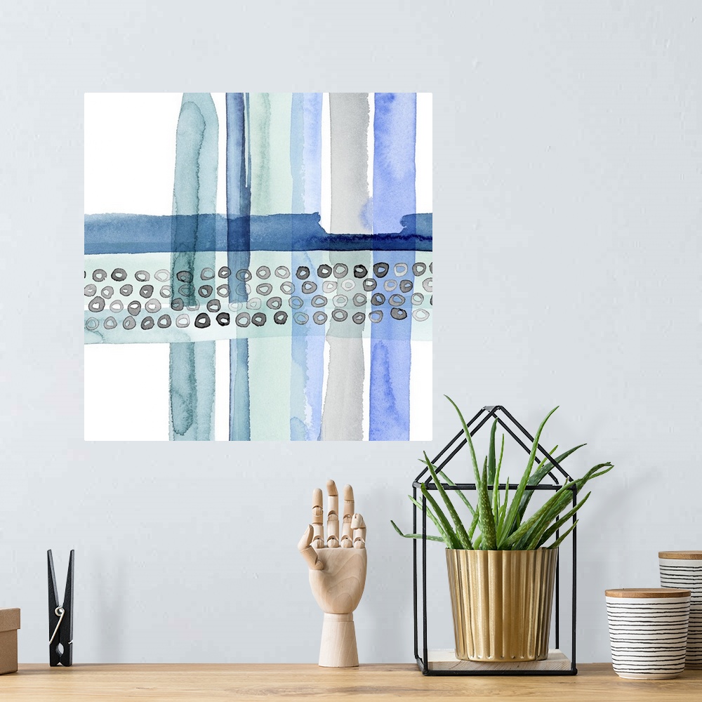 A bohemian room featuring Abstract watercolor painting made with cool tones and movement on a square background.
