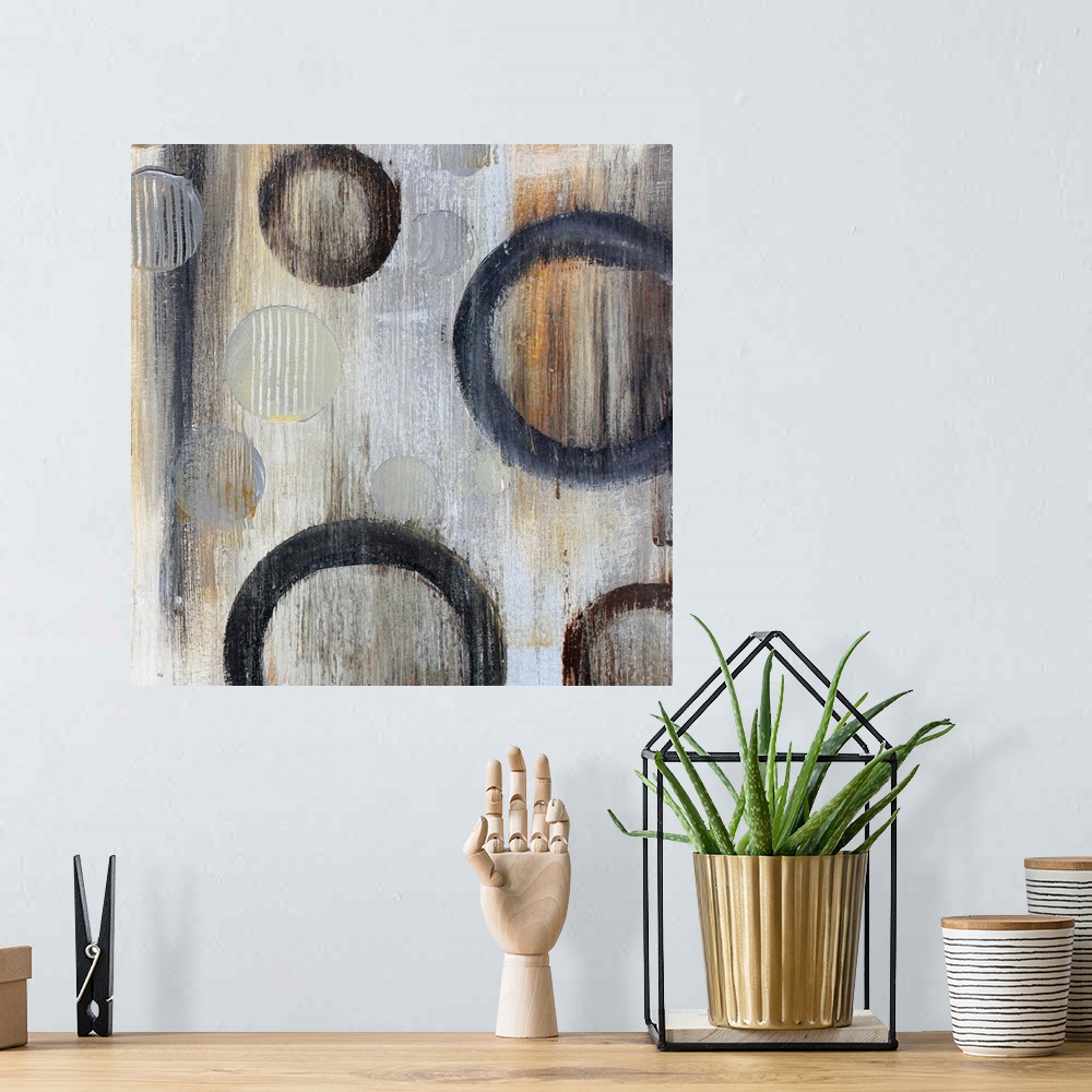 A bohemian room featuring Abstract artwork of circle floating against a gray background with an overall grungy look.