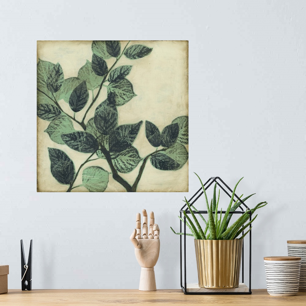 A bohemian room featuring Home decor artwork of muted green leaves on a twig against a light pale green background.