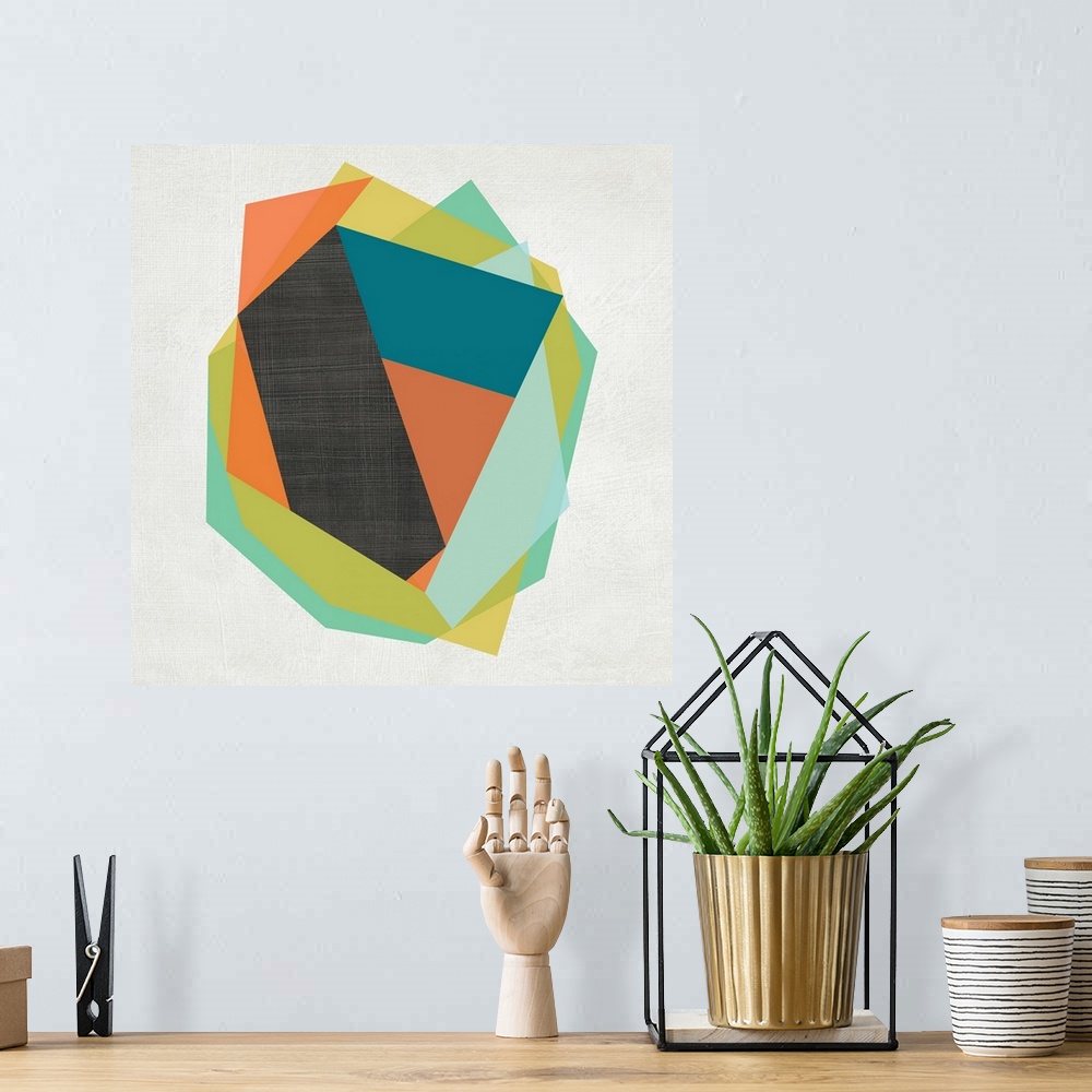 A bohemian room featuring Vibrant polygonal shapes layer on top of each other over a white linen background with a dark gra...