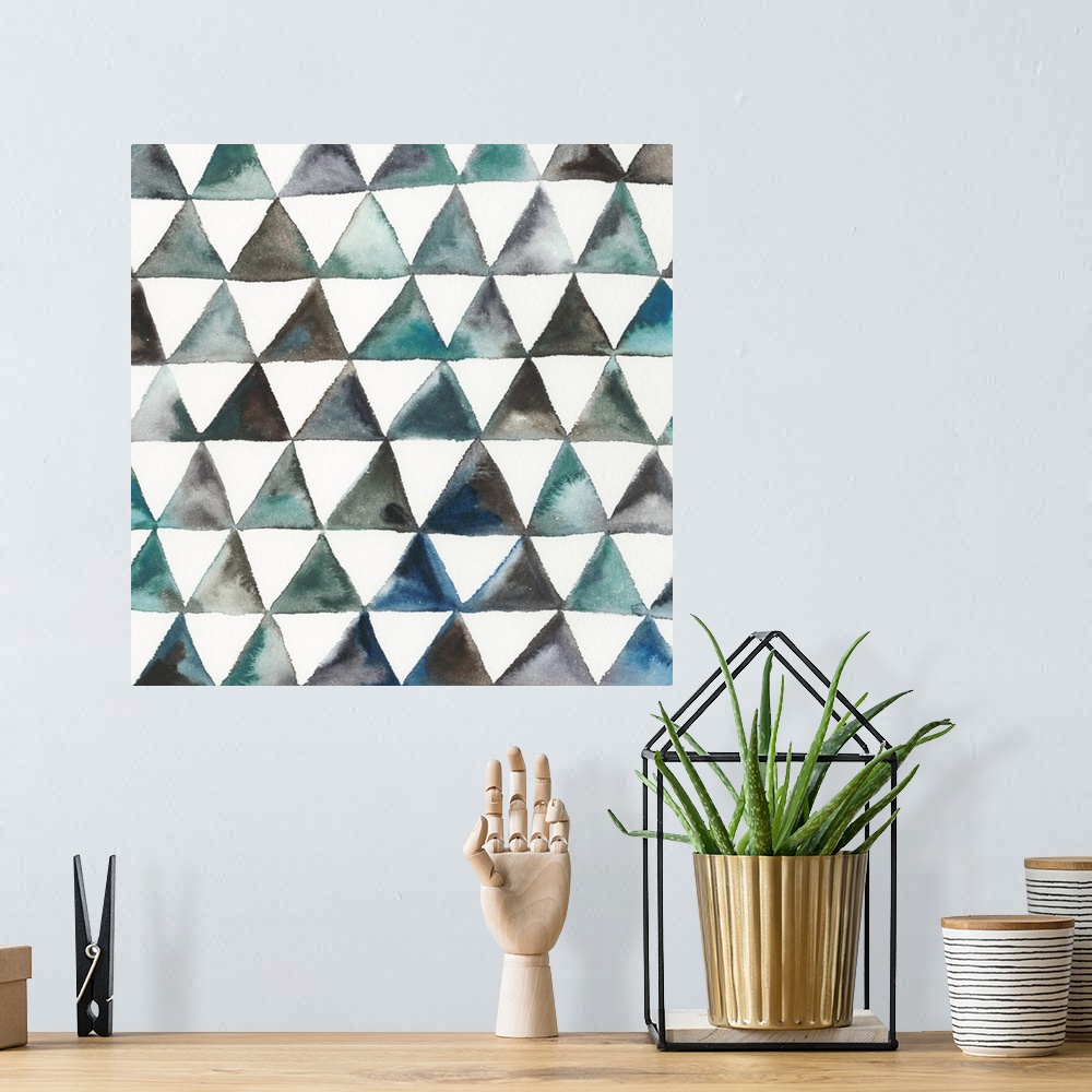 A bohemian room featuring Square abstract decor with triangles in lines creating a pattern in shades of blue, green, and br...